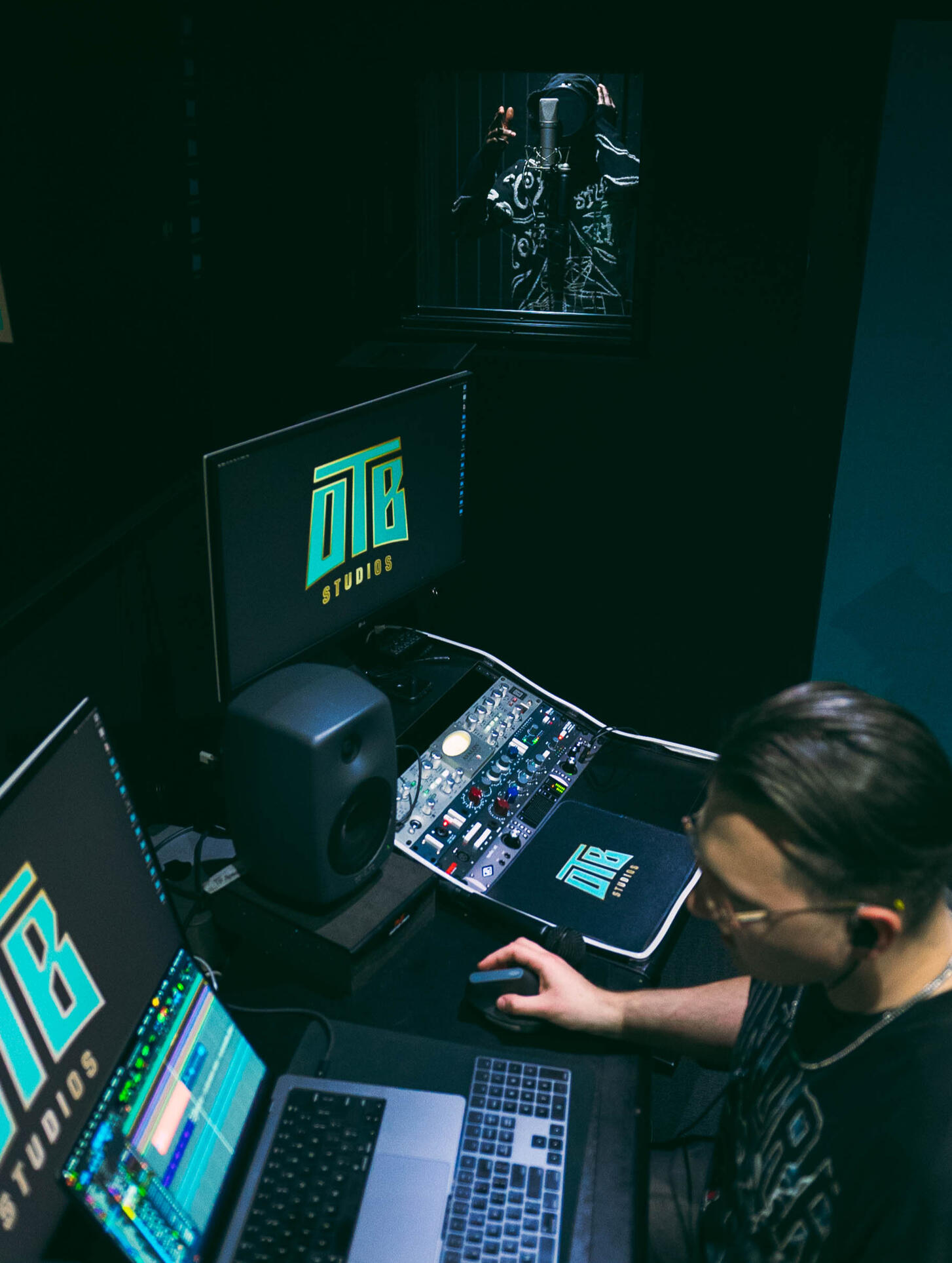 Luka working in a recording studio with Octavian in the vocal booth.